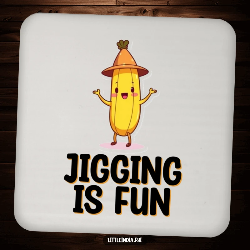 Funny Banana Coaster displaying a cheerful banana in a conical hat doing a jig, offering protection and humor for tables.