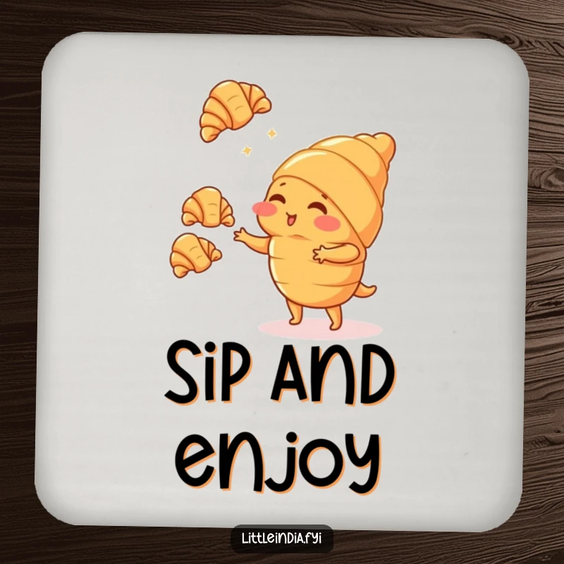 Funny blushing croissant character juggling tiny croissants printed on a protective drink coaster, adding sweet humor.